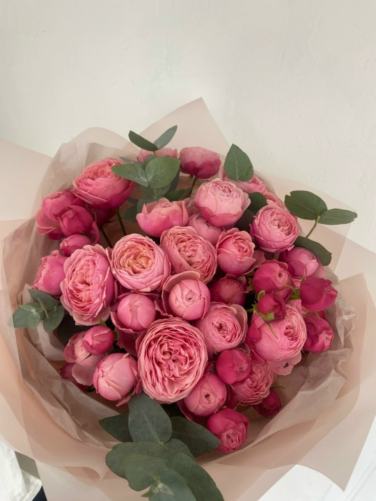 Пышный букет пионовидных кустовых роз с эвкалиптом