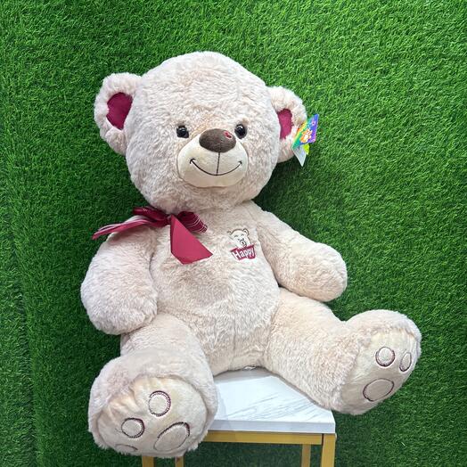 Светлый мишка с красным бантом