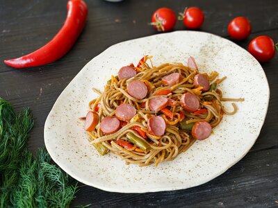 Вок с охотничьими колбасками и гречневой лапшой